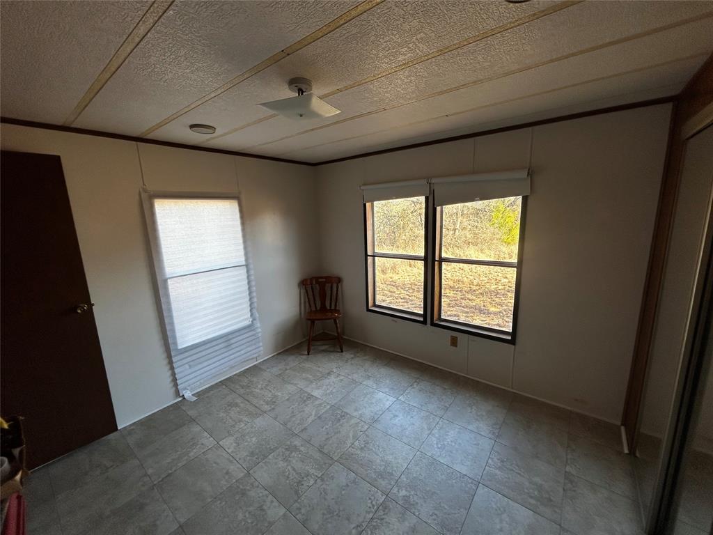 194 Lakeview Court Sunset, TX 76270 - Photo 19 of 19 an empty room with windows