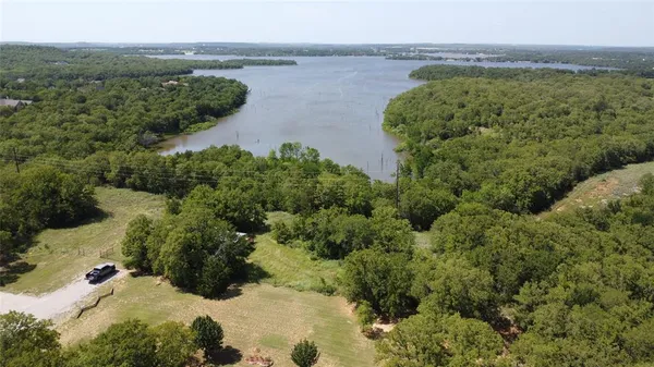 an aerial view of a houses with a lake view