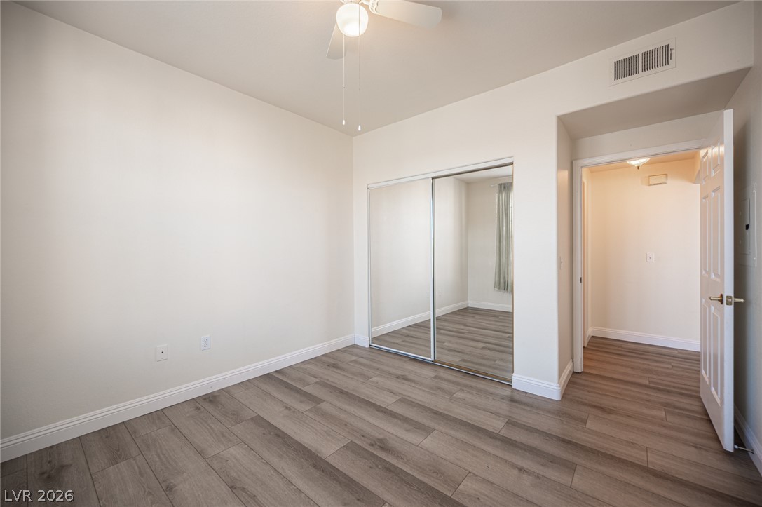 8555 West Russell Road, Unit 2062 Las Vegas, NV 89113 - Photo 29 of 35 A well-proportioned room showcasing rich wood flooring and ample mirrored closet storage.