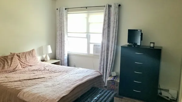 a bedroom with a bed and a window