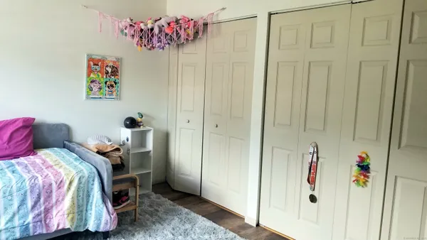 a bedroom with a bed and a mirror