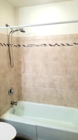 a bathroom with a shower and a bathtub