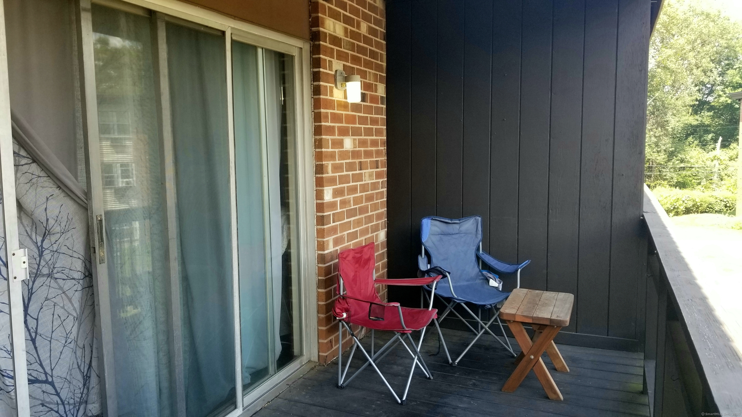 75 Balance Rock Road, Unit 11 Seymour, CT 06483 - Photo 5 of 21 a view of a balcony with chair and table