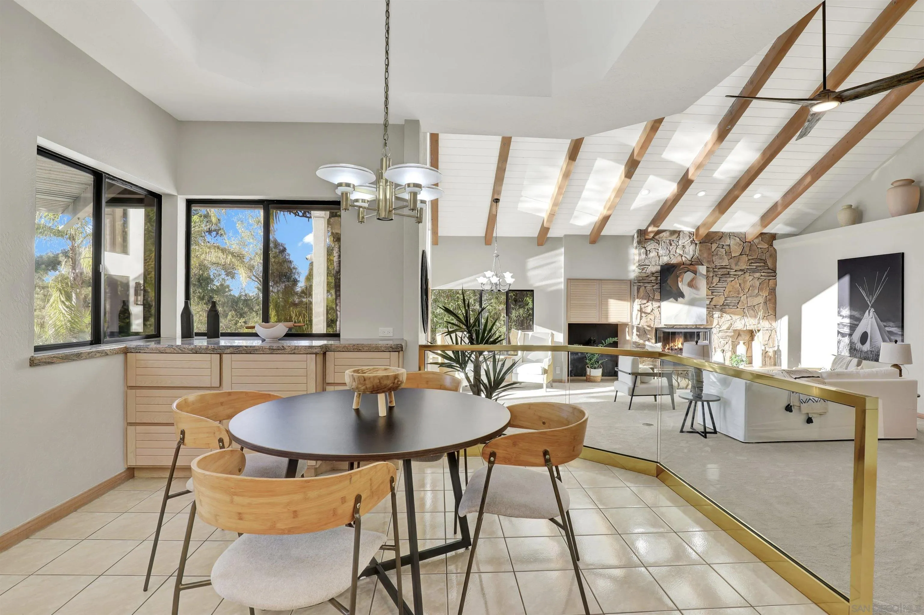 17801 Joyas Court Poway, CA 92064 - Photo 11 of 31 a dining room with wooden floor a chandelier a wooden table and chairs
