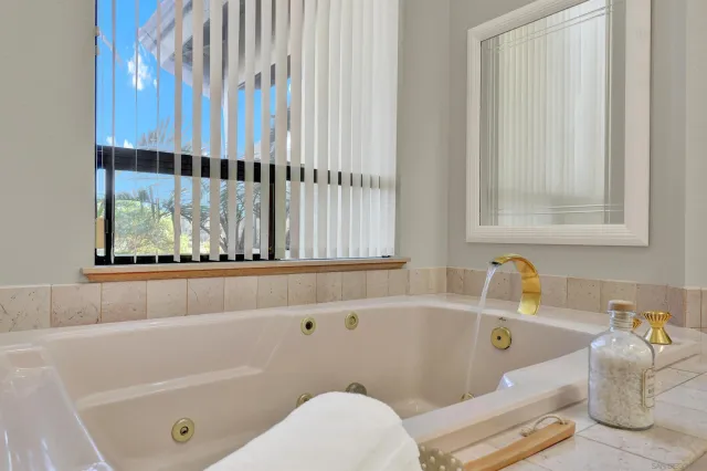 a bathroom with a bathtub and a window