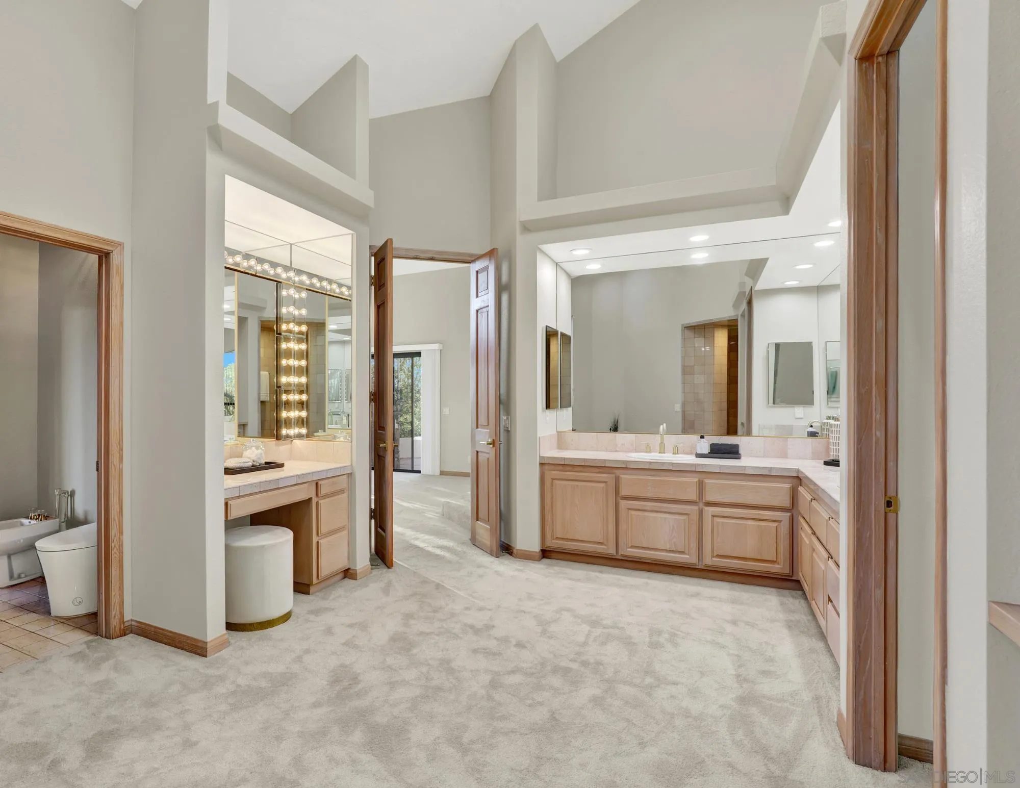 17801 Joyas Court Poway, CA 92064 - Photo 19 of 31 a large bathroom with a large mirror vanity and shower
