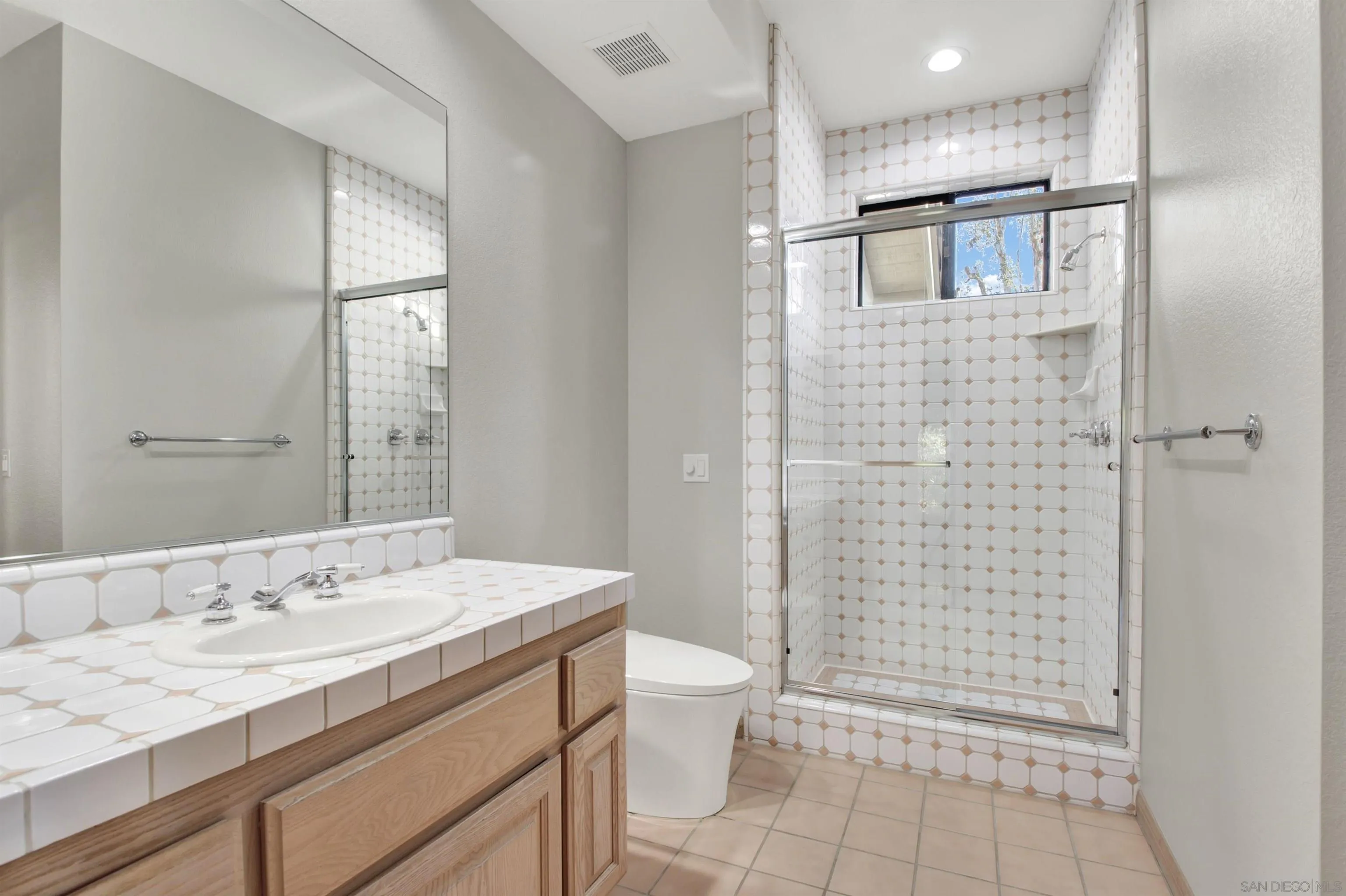 17801 Joyas Court Poway, CA 92064 - Photo 22 of 31 a bathroom with a granite countertop sink a toilet and shower