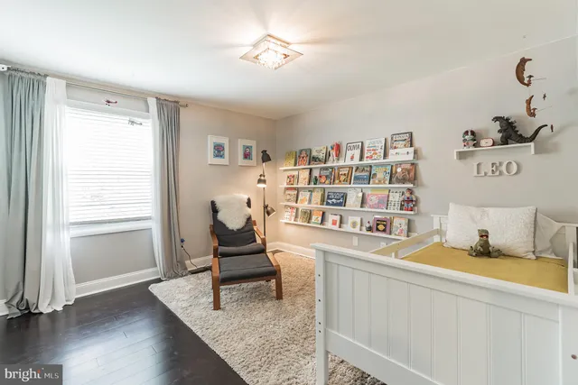 a living room with furniture and a book shelf