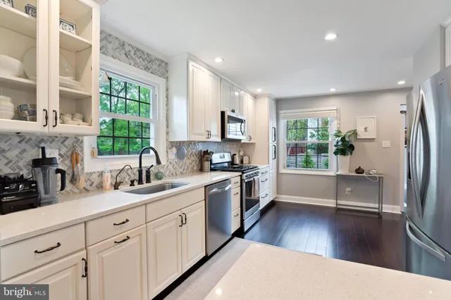 a kitchen with a sink a window and appliances