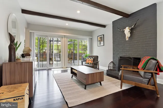 a living room with furniture fireplace and a large window