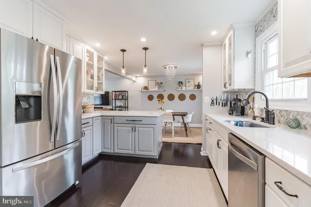 a kitchen with white cabinets stainless steel appliances and sink