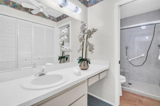 a bathroom with a glass shower and a mirror