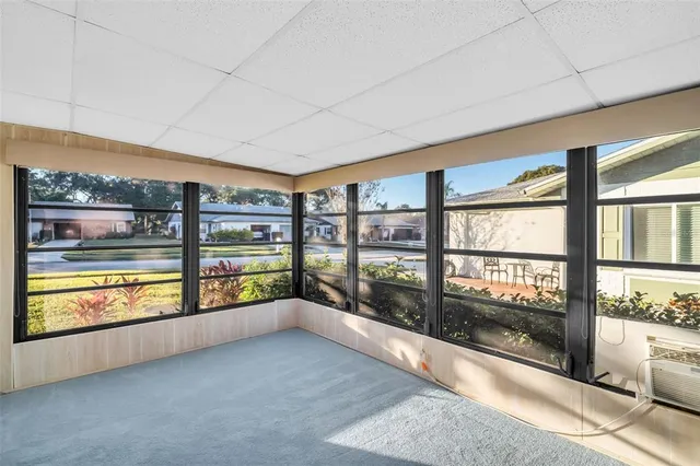 a view of a living room hardwood floor and a large window