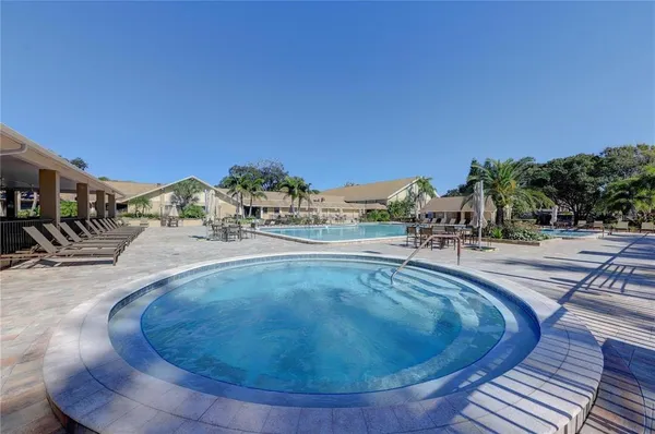 a view of swimming pool with a yard and plants