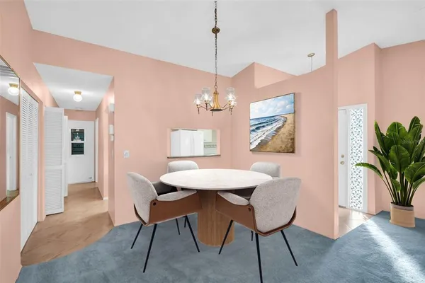 a living room with furniture a dining table and a fireplace