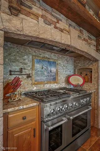 a stove top oven sitting inside of a kitchen