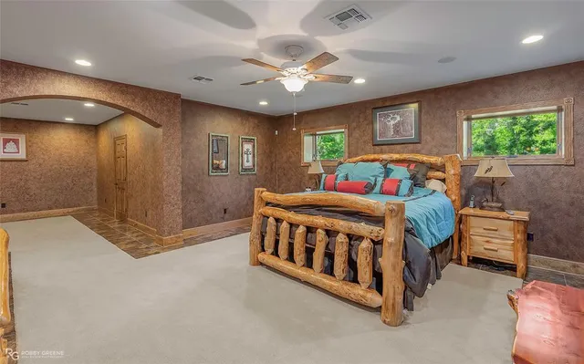 a white bed sitting in a room next to a window