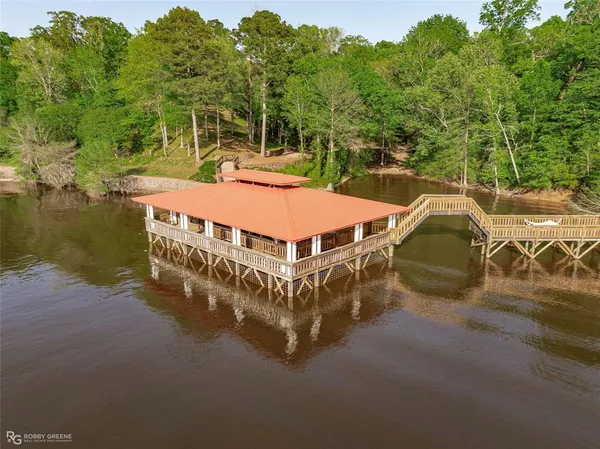 a view of a house with pool and sitting area
