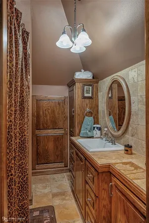 a bathroom with a sink a mirror and shower