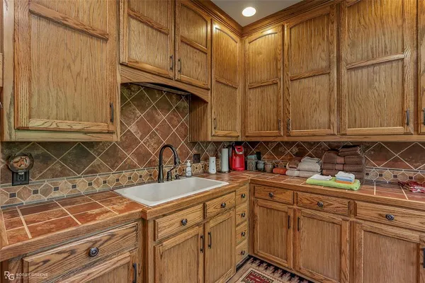 a kitchen with stainless steel appliances wooden cabinets and a sink
