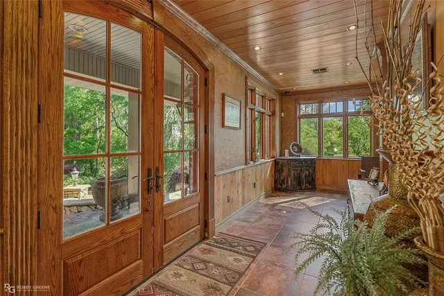 a large room with a large window and furniture