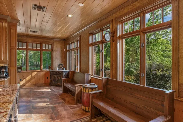 a living room with furniture and large windows