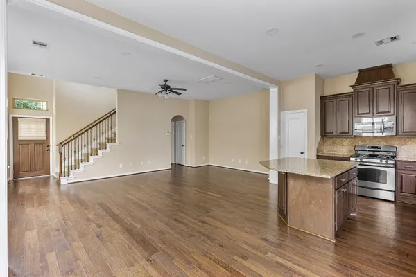 a view of kitchen with wooden floor and electronic appliances