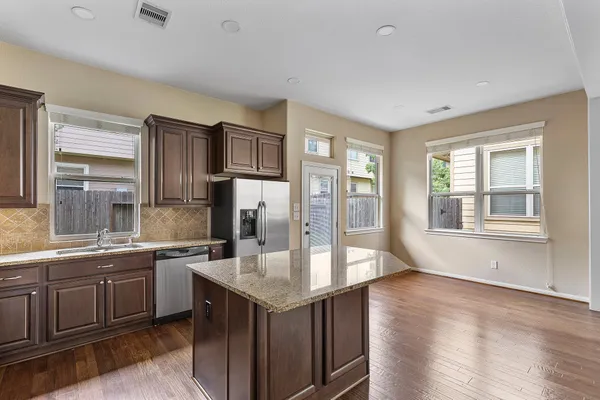 a kitchen with a sink stove and refrigerator