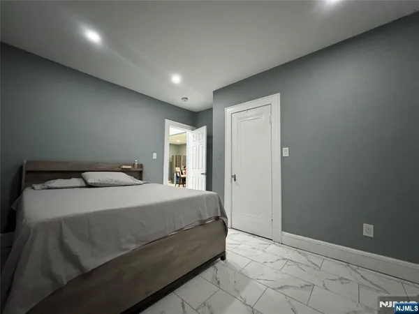 a room with a bed and lamp