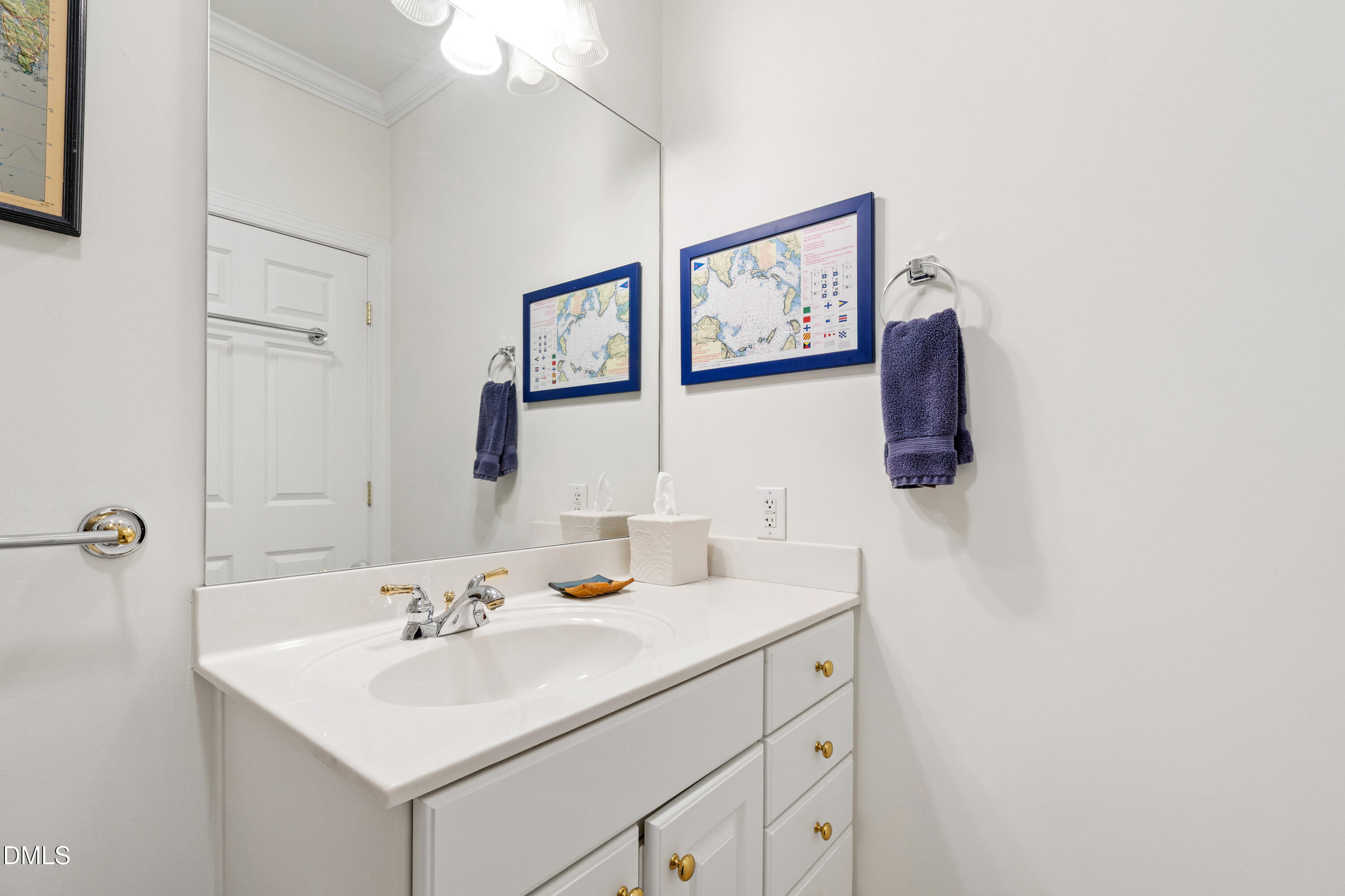 3700 Baron Cooper Pass, Unit 105 Raleigh, NC 27612 - Photo 34 of 49 a bathroom with a sink and a mirror