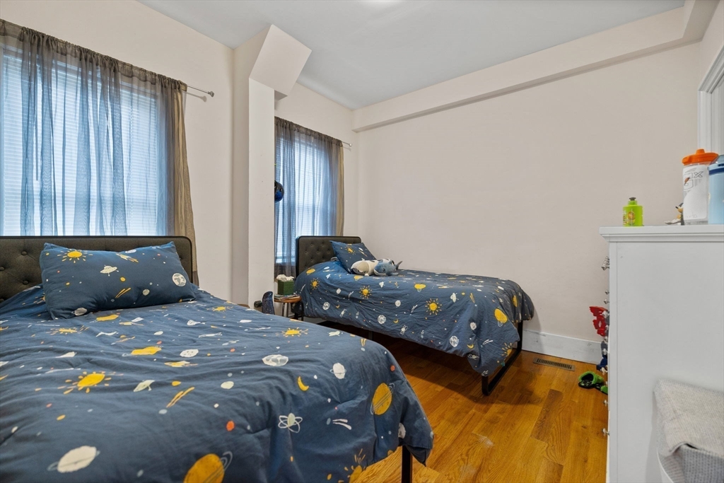 33 Clinton Street Framingham, MA 01702 - Photo 13 of 26 a bedroom with a bed and a dresser