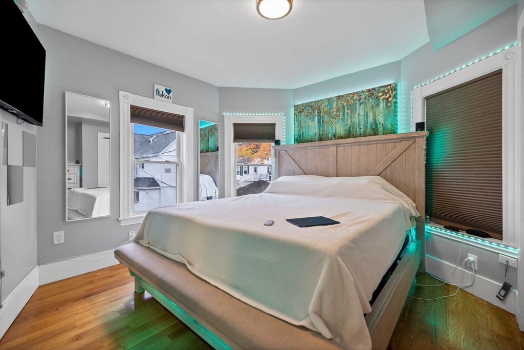 33 Clinton Street Framingham, MA 01702 - Photo 16 of 26 a bedroom with a bed and a flat screen tv