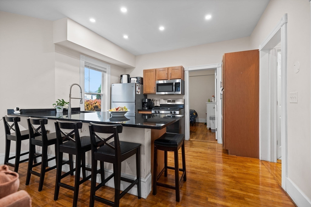 33 Clinton Street Framingham, MA 01702 - Photo 2 of 26 a kitchen with a table and chairs in it