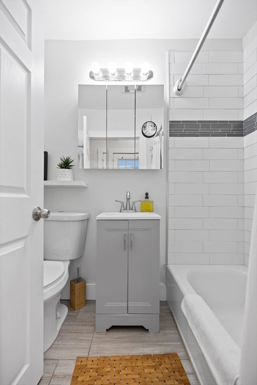 33 Clinton Street Framingham, MA 01702 - Photo 8 of 26 a bathroom with a sink a toilet and bathtub