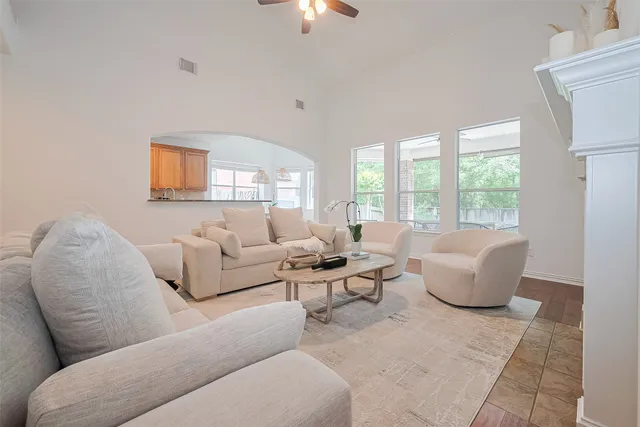 a living room with furniture a fireplace and a chandelier