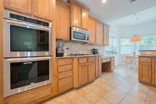 a kitchen with stainless steel appliances granite countertop a sink and cabinets