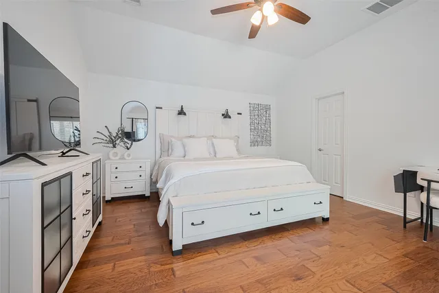 a bedroom with a bed and a flat screen tv