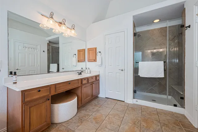 a spacious bathroom with a granite countertop sink toilet mirror and bathtub