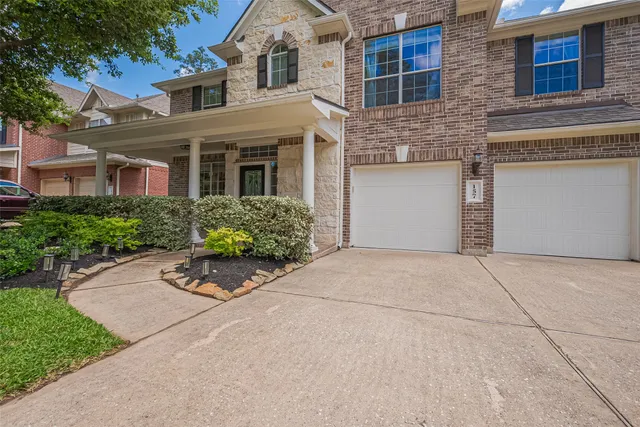 front view of a brick house with a bench in front of it