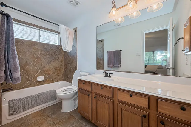 a bedroom with two beds and painting on the wall