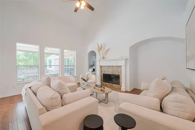 a living room with furniture a large window and a fireplace