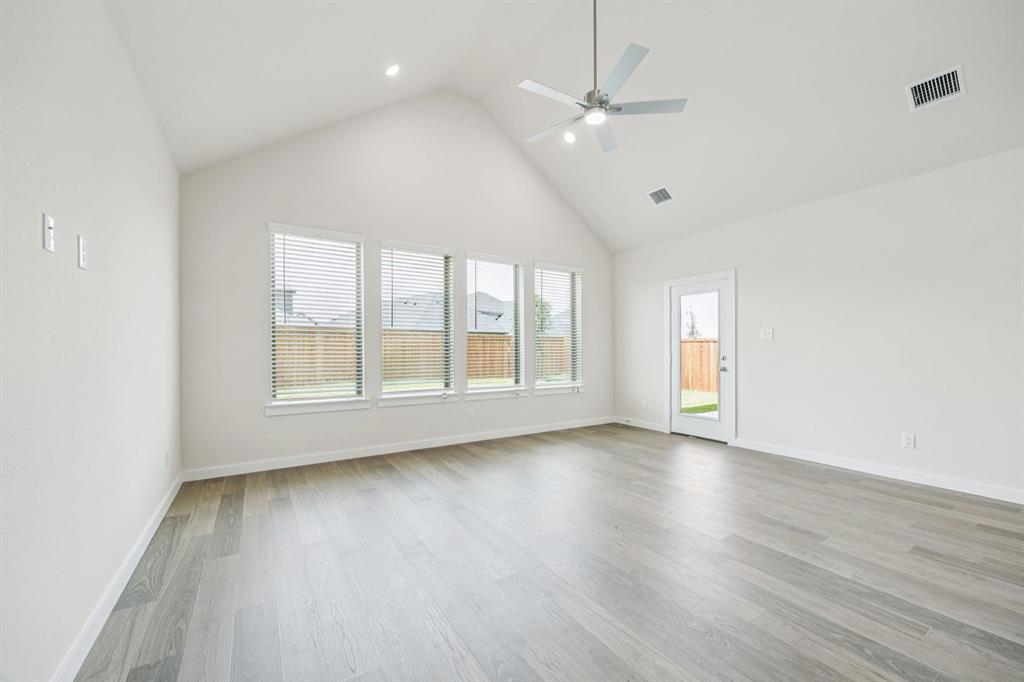 483 Sierra Ridge Lavon, TX 75166 - Photo 10 of 29 an empty room with wooden floor and windows