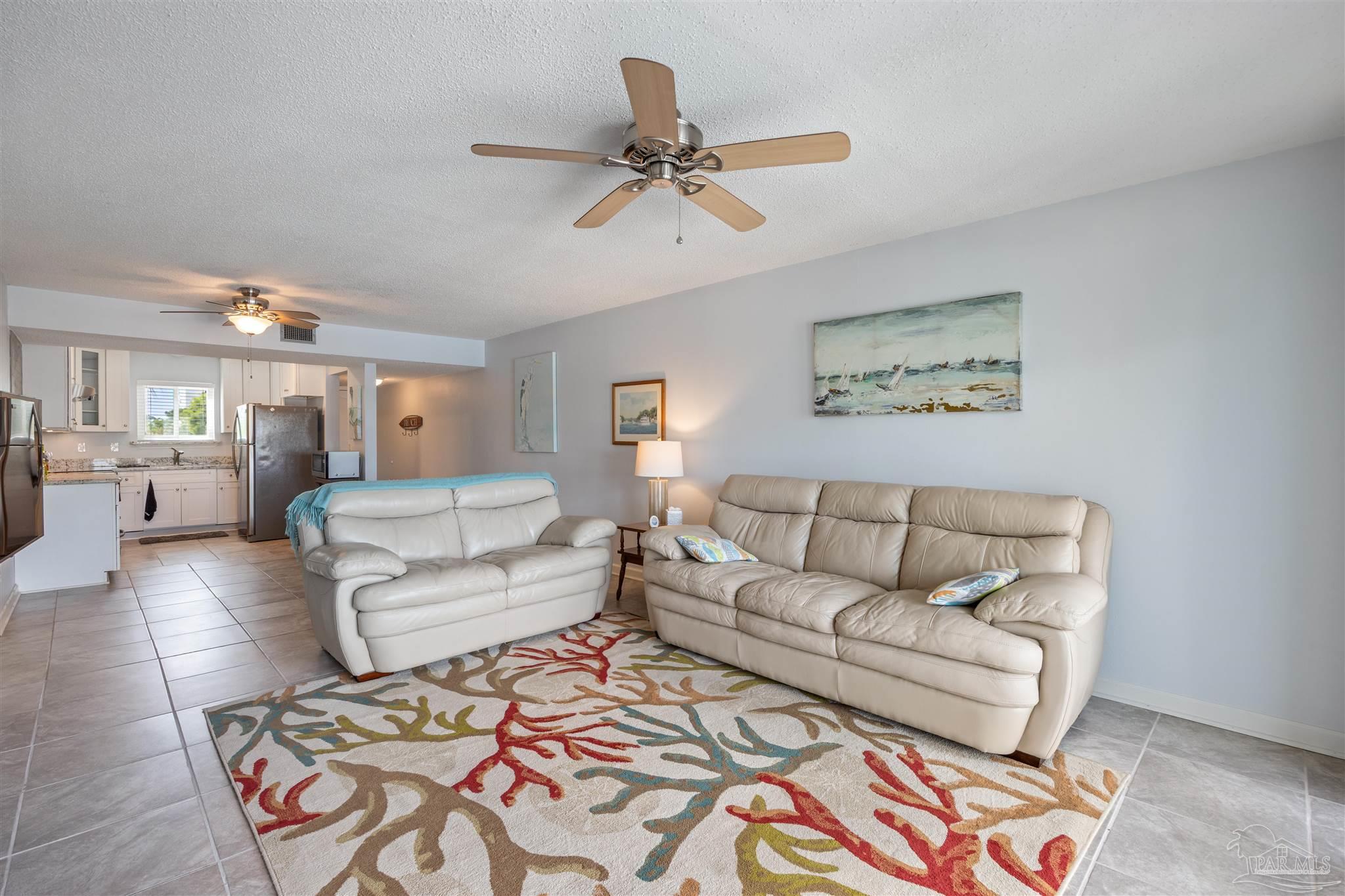 14100 River Road, Unit 228B Pensacola, FL 32507 - Photo 13 of 41 a living room with furniture and a chandelier