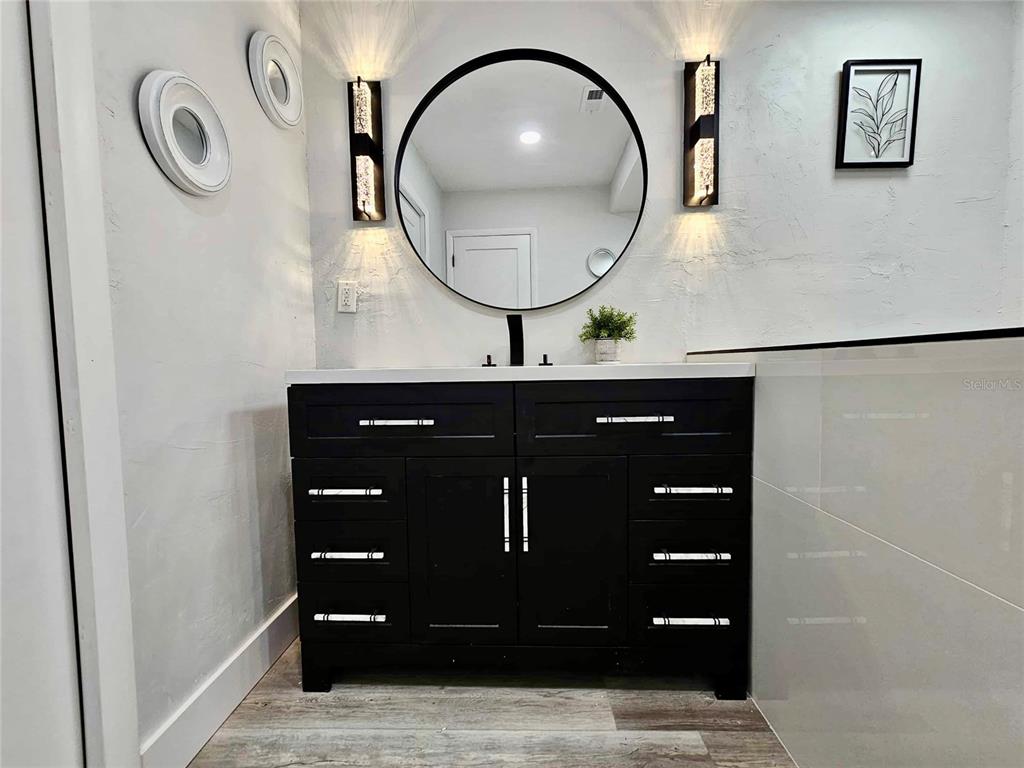 5407 Southwest 82 Terrace Gainesville, FL 32608 - Photo 16 of 31 a bathroom with a sink and a mirror