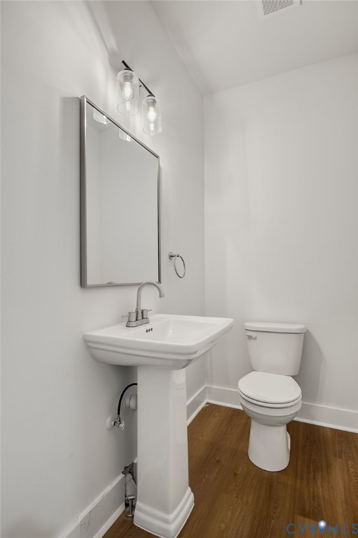 1619 12th Street Victoria, VA 23974 - Photo 11 of 30 a bathroom with a toilet a sink and mirror