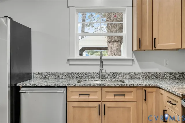 a view of a kitchen with a sink cabinets and a ceiling fan