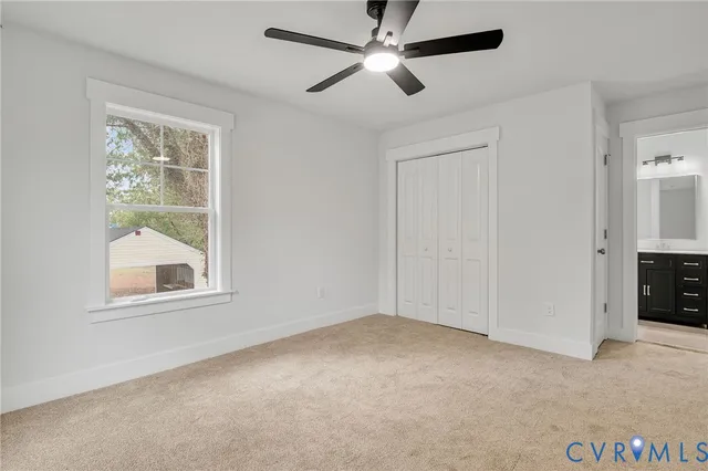 a view of an empty room and a ceiling fan