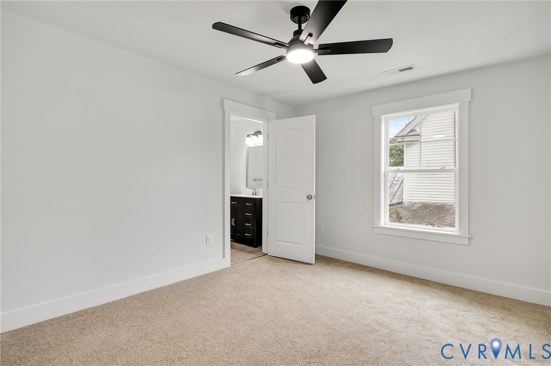 1619 12th Street Victoria, VA 23974 - Photo 22 of 30 an empty room with ceiling fan and windows