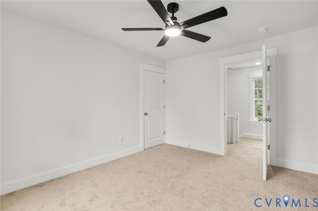 1619 12th Street Victoria, VA 23974 - Photo 23 of 30 an empty room with a ceiling fan and carpet
