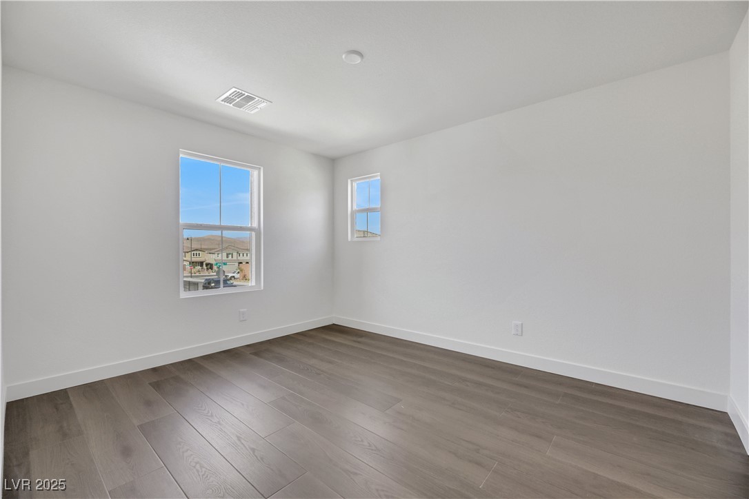 Empty room with wood finished floors and baseboards